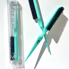 Two BIGGER TEASE combs crossing each other with a BIGGER TEASE comb in a box