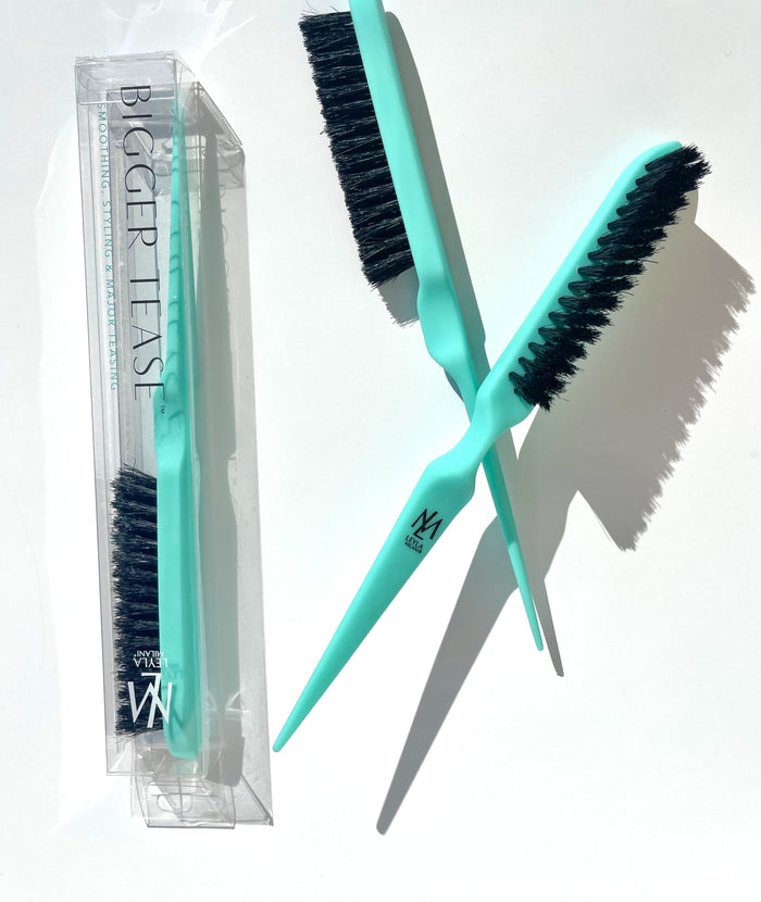 Two BIGGER TEASE combs crossing each other with a BIGGER TEASE comb in a box