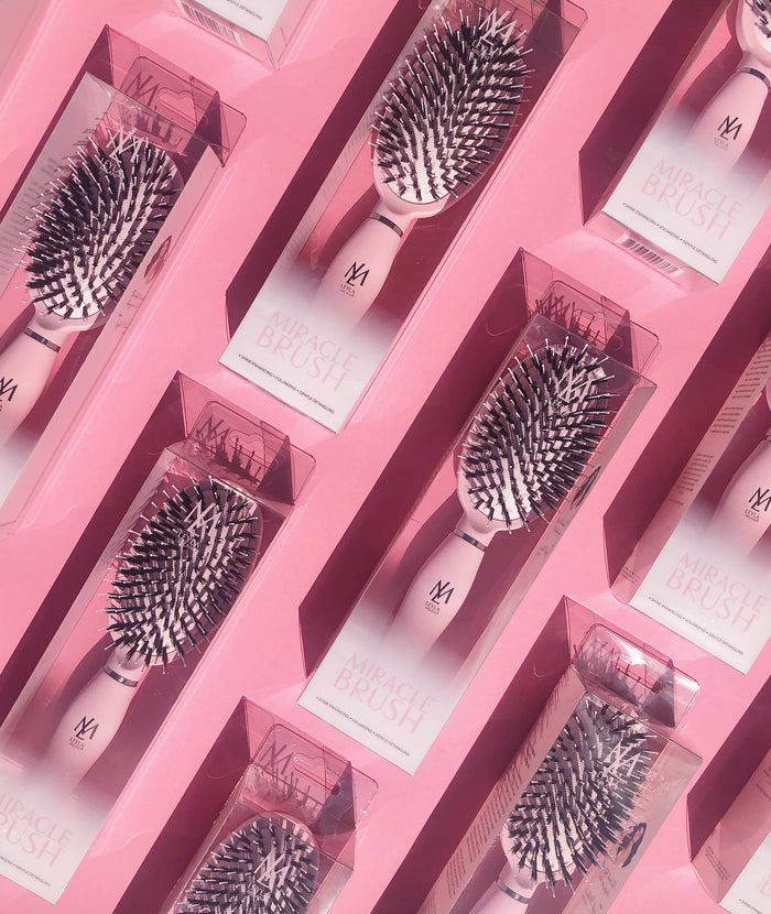 Several Pink Edition Miracle Brushes in their boxes